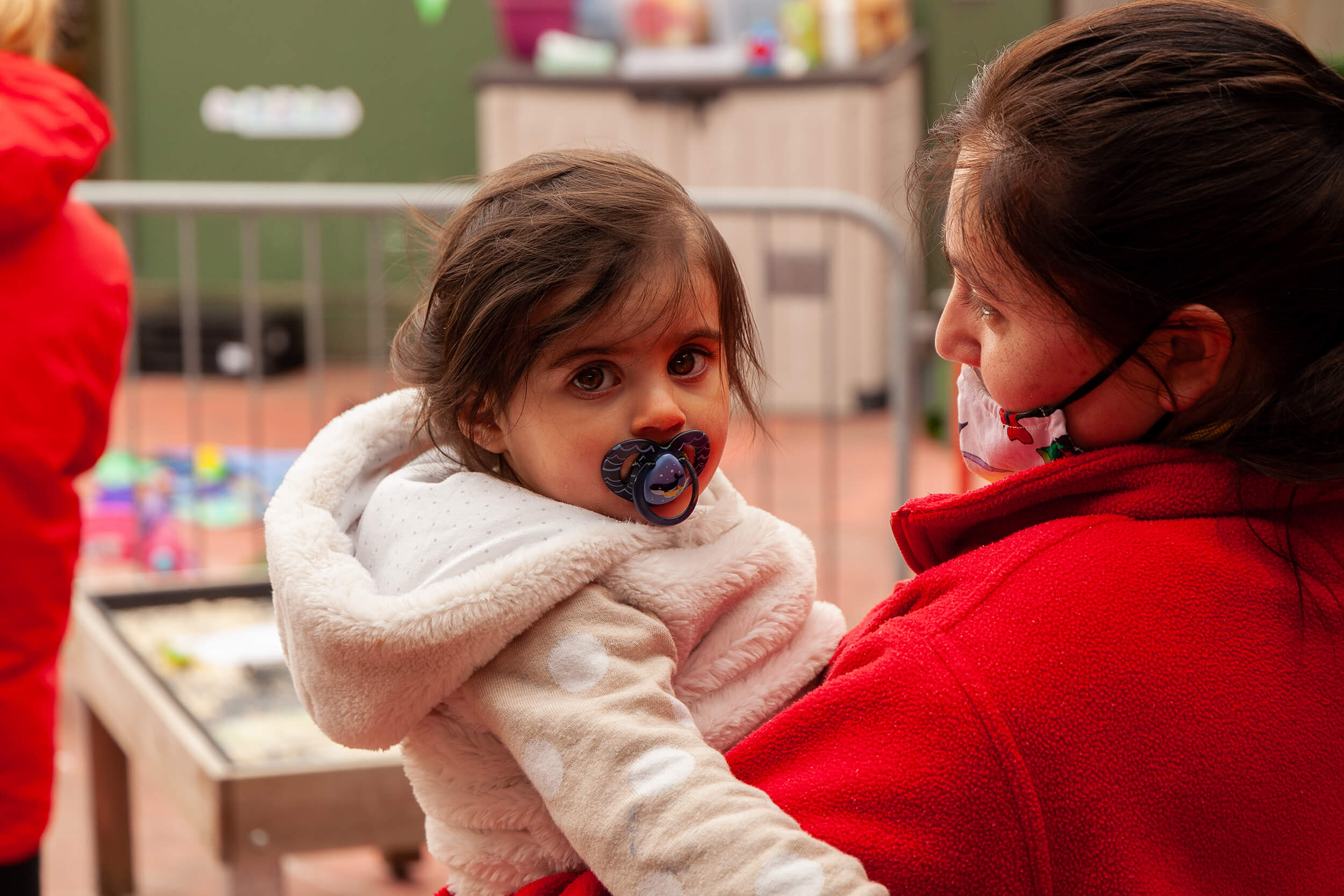 nursery nurse and girl with a dummy