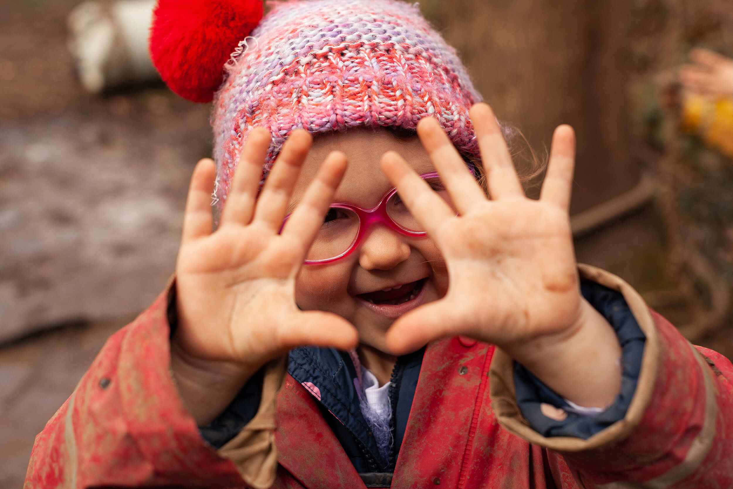 Girl showing muddy hands