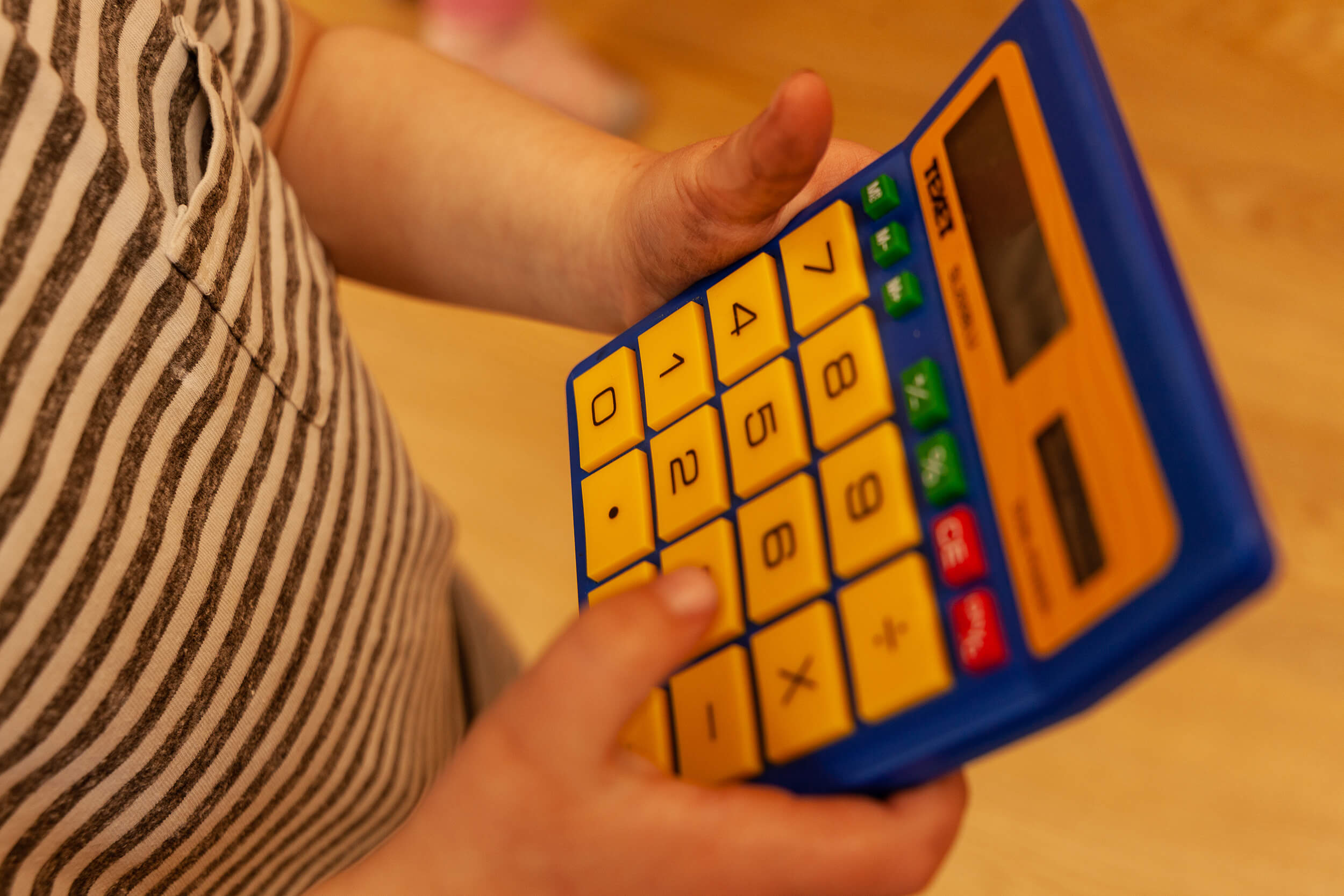 Boy playing with a calculator