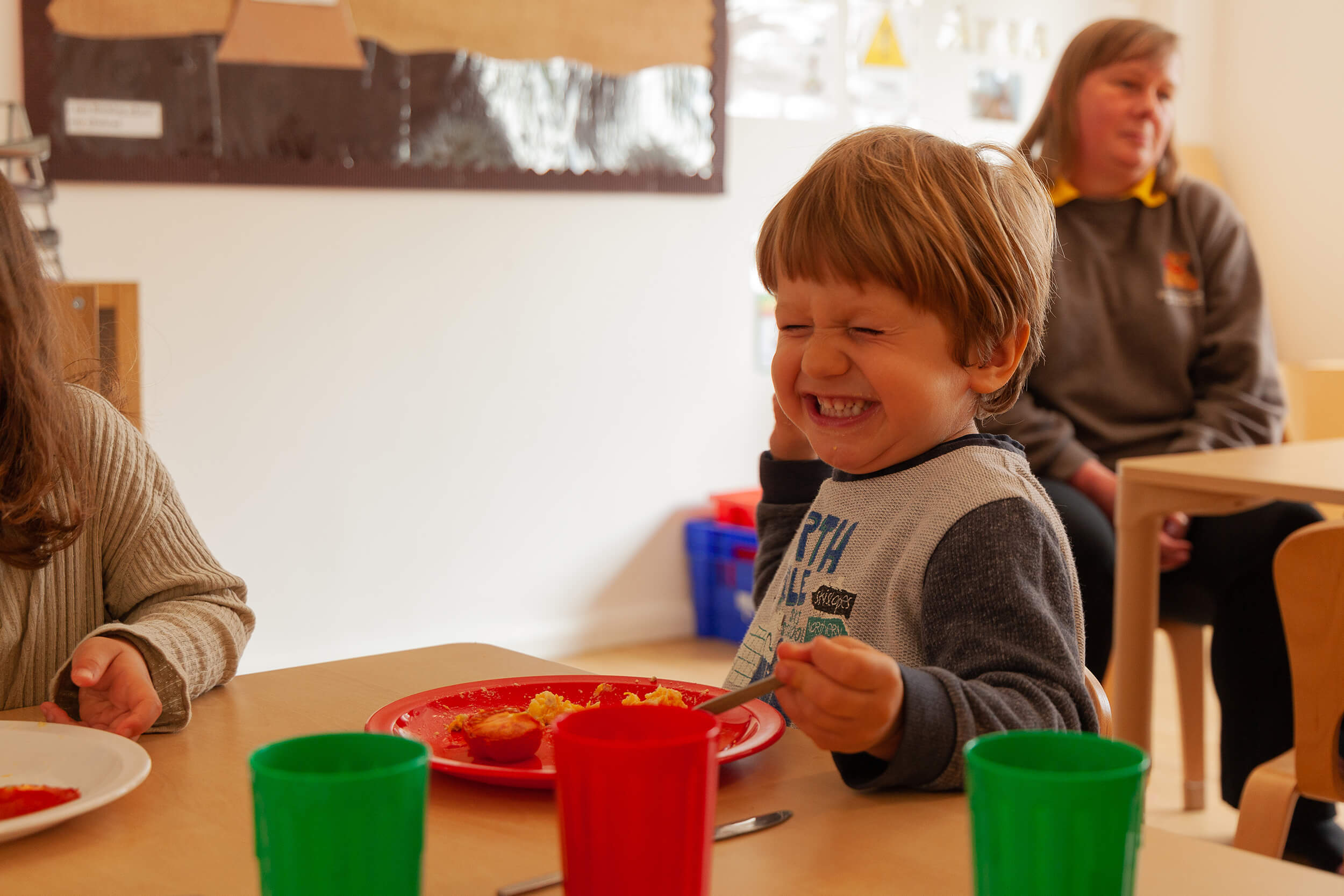 Boy laughing at the table