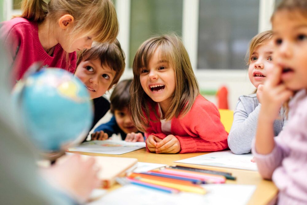 Kids smiling at the table