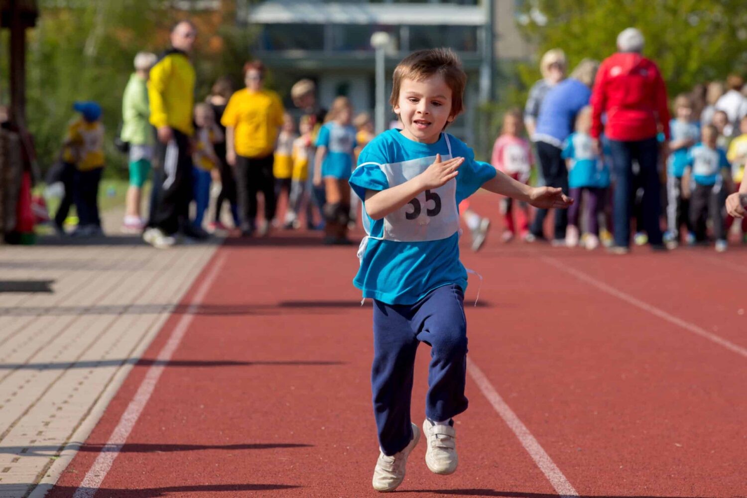 Young preschool children, running on track in a marathon competi