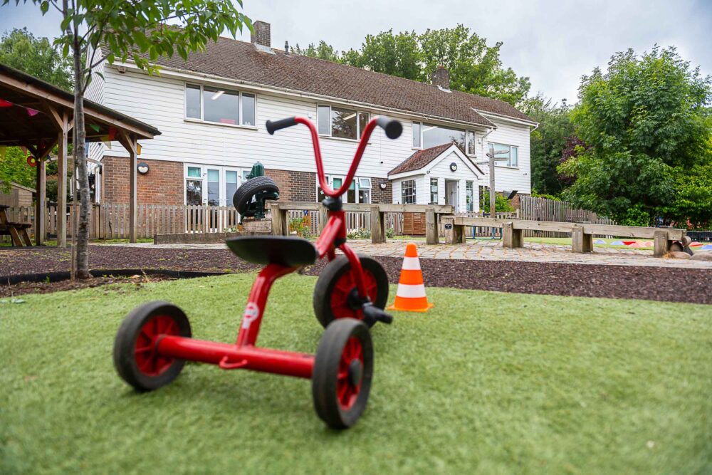 Tricycle parked with Graces nursery house in the background