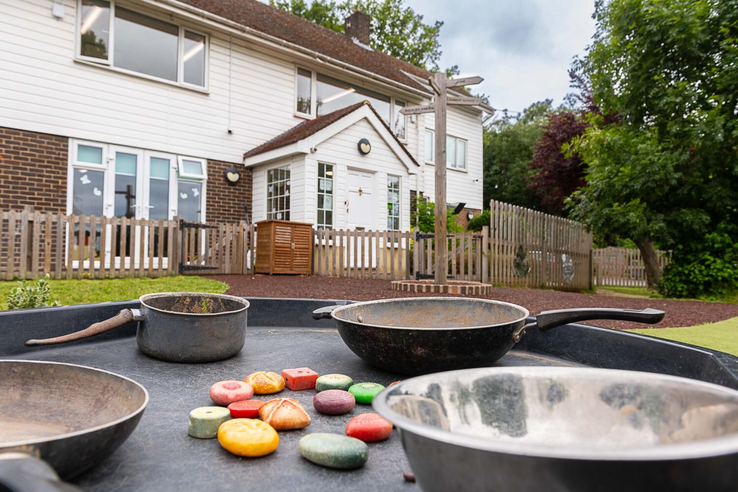 Grace's nursery house garden area with splash mat full of pots and pans