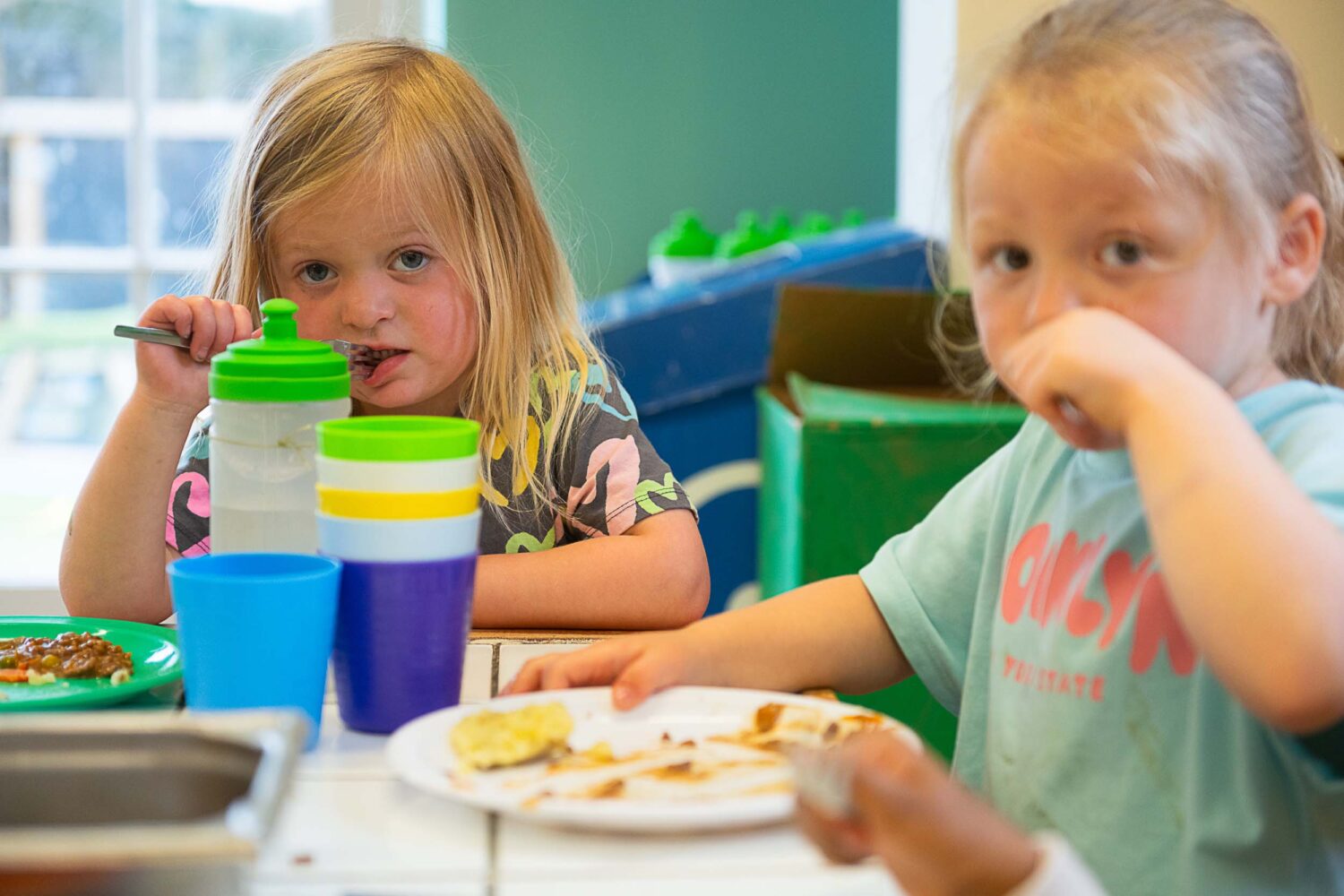 Two girls sitting eating lunch
