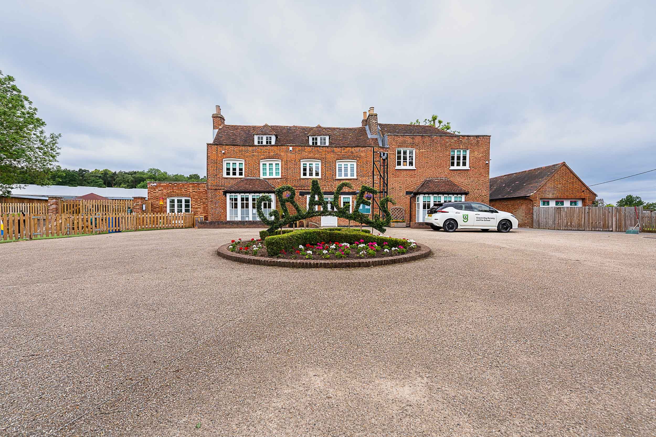 Graces Day Nursery front view with driveway and foliage spelling 