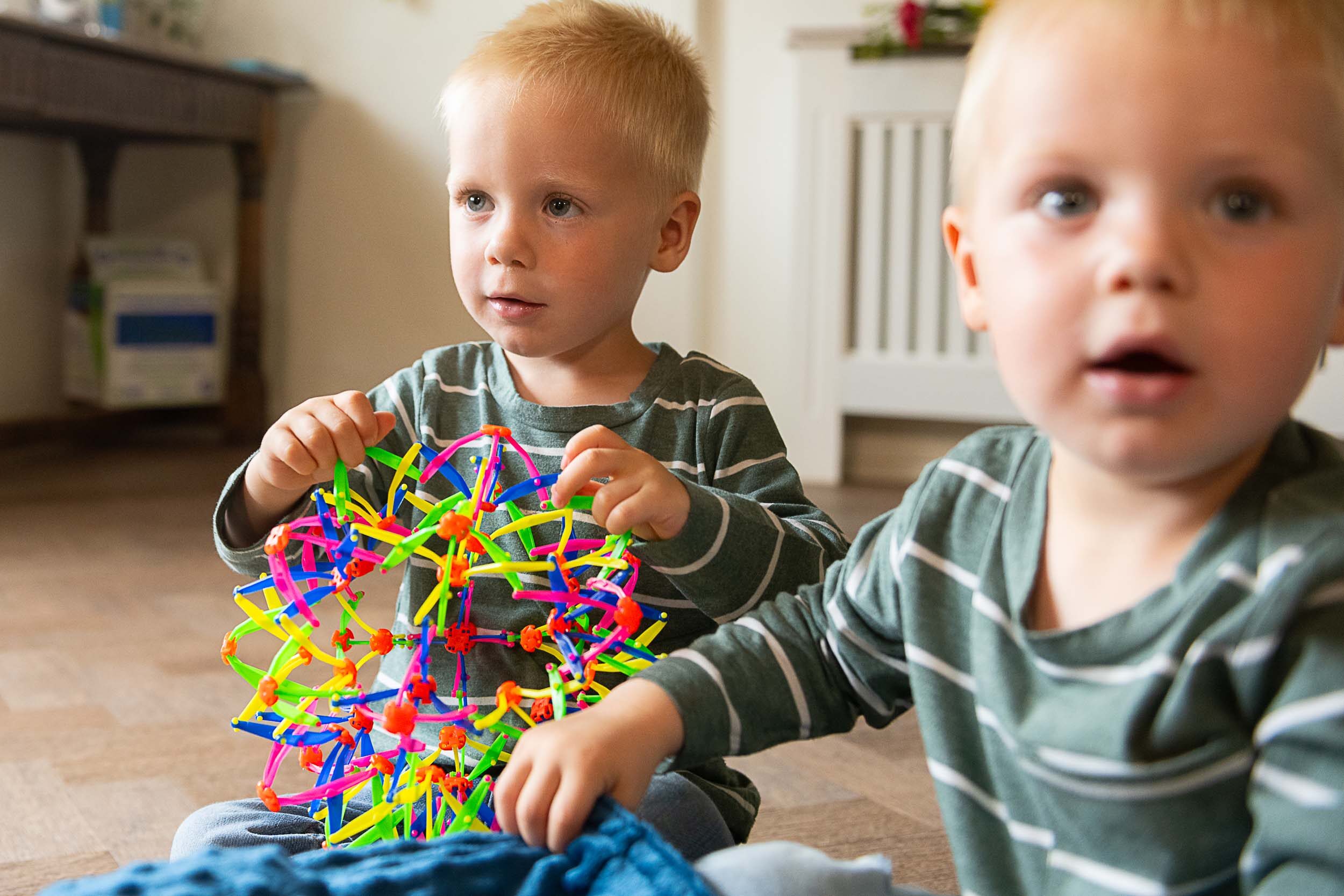 Two young SEN boys playing with a toy