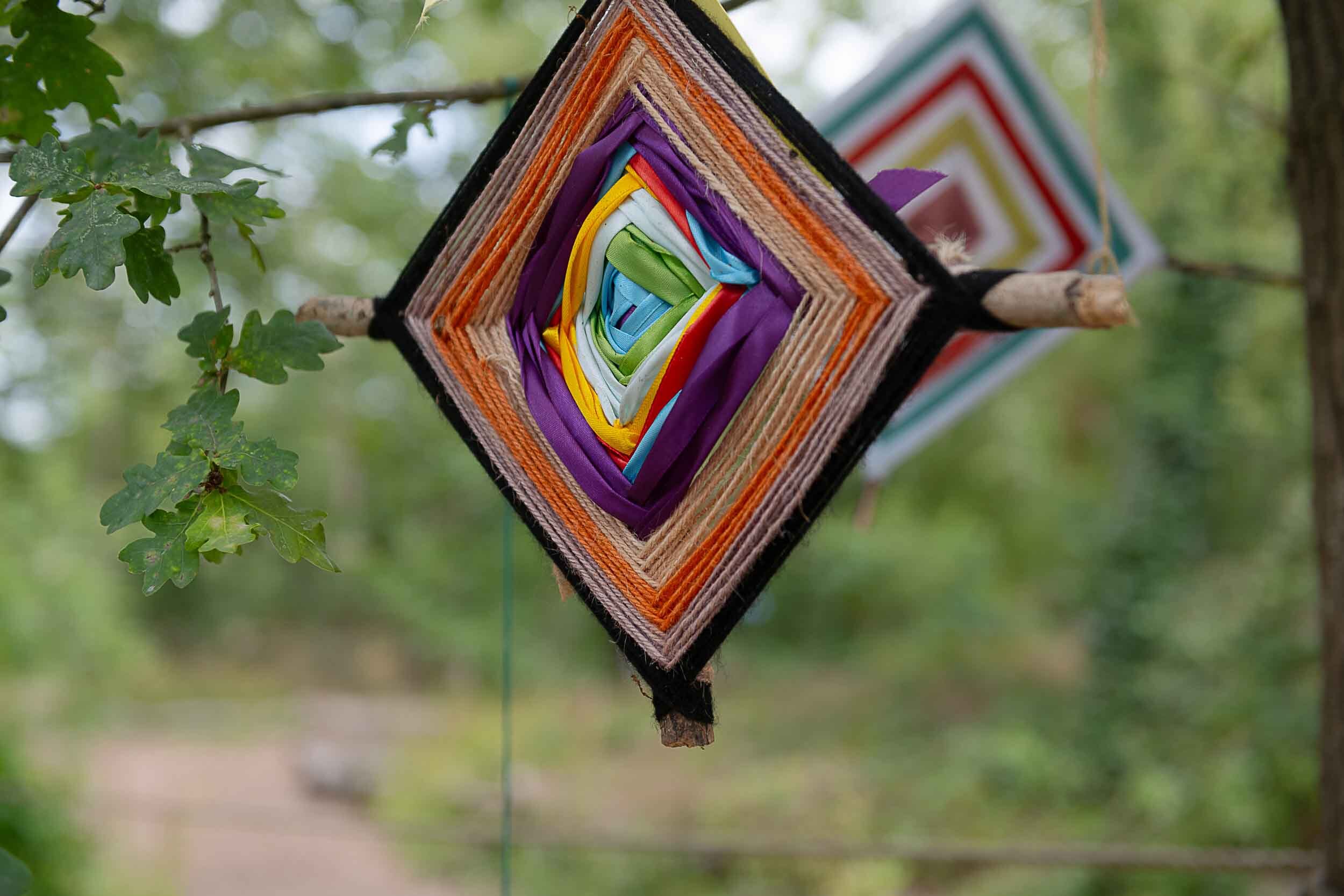 A colourful dream catcher hanging in the tree